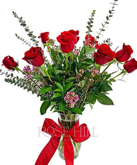 One dozen long-stemmed roses and greenery