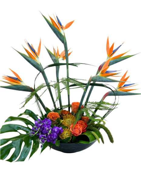 Birds of Paradise and greenery in a clear glass vase