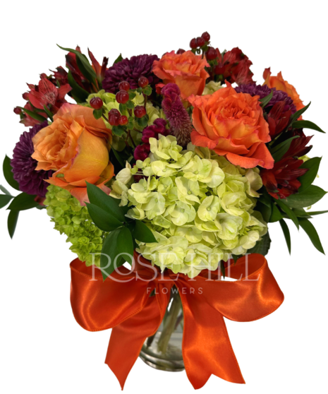 Colorful gemstone arrangement in a clear vase.
