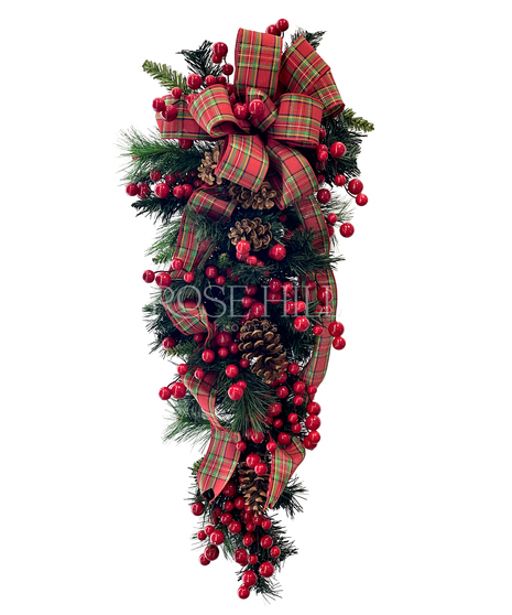 Festive door swag adorned with berries, pine cones and a lovely holiday ribbon.