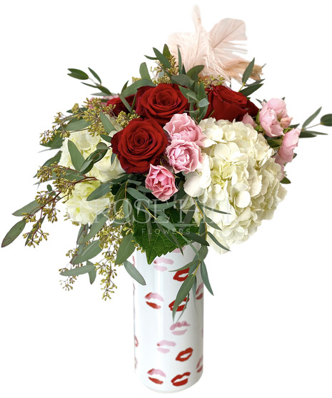 Stunning arrangement of red roses, pink spray roses, hydrangea and more plus an ostrich feather to top it off!