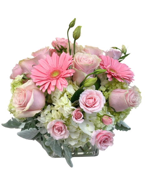 Clear glass cube with  amix of white hydrangea, pink gerberas, and a variety of pink and white flowers