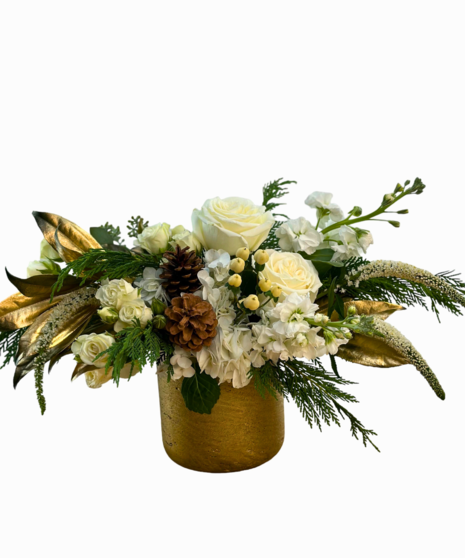 Holiday arrangement in a golden cube with cream roses, pine cones, greens and more for a perfect holiday arrangement.