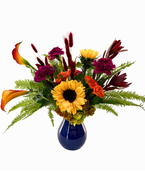 Colorful gemstone arrangement in a clear vase.