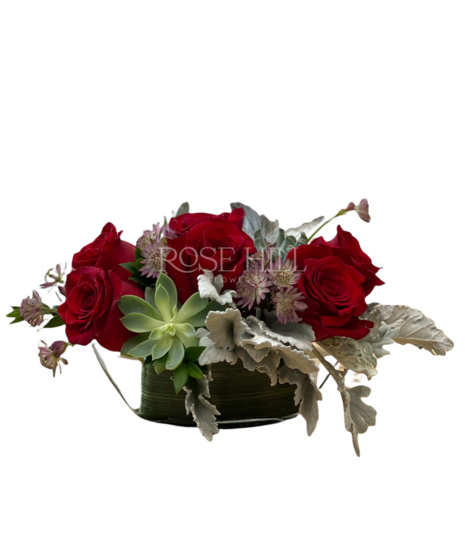 Love Boat is a lovely, quaint cluster of roses, succulents, heather and greens in a clear glass boat shaped vase