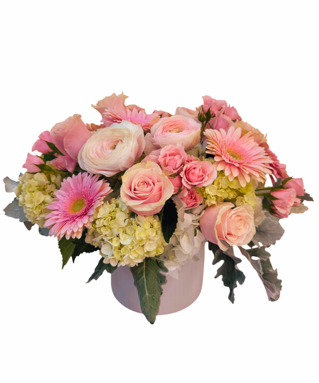 Clear glass cube with  amix of white hydrangea, pink gerberas, and a variety of pink and white flowers